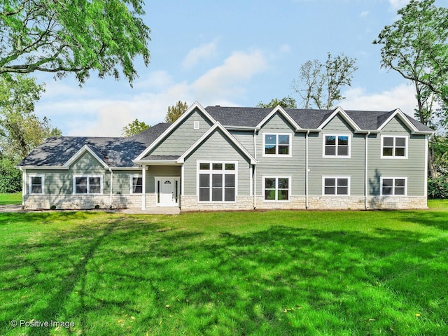 rear view of property with a yard