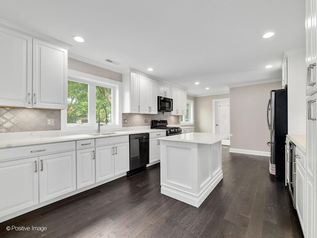 kitchen with stainless steel appliances, sink, and white cabinets