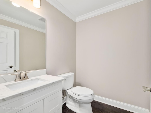 bathroom featuring hardwood / wood-style flooring, ornamental molding, vanity, and toilet