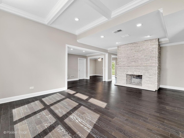 unfurnished living room featuring a stone fireplace, beamed ceiling, wood-type flooring, ornamental molding, and ceiling fan