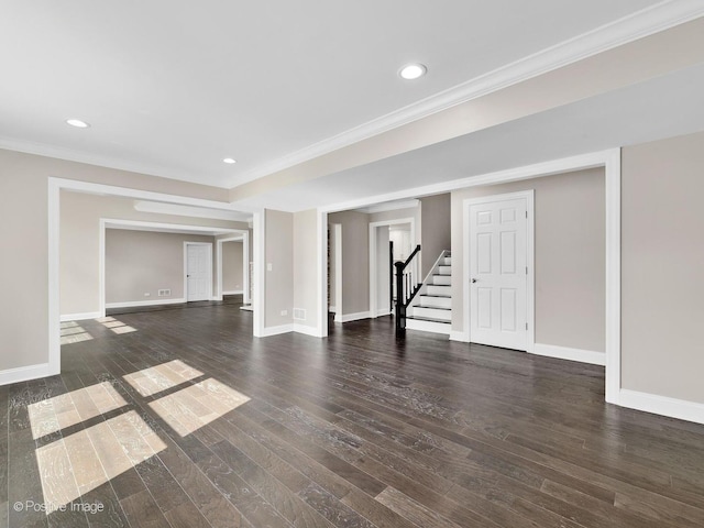 unfurnished living room featuring crown molding and dark wood-type flooring