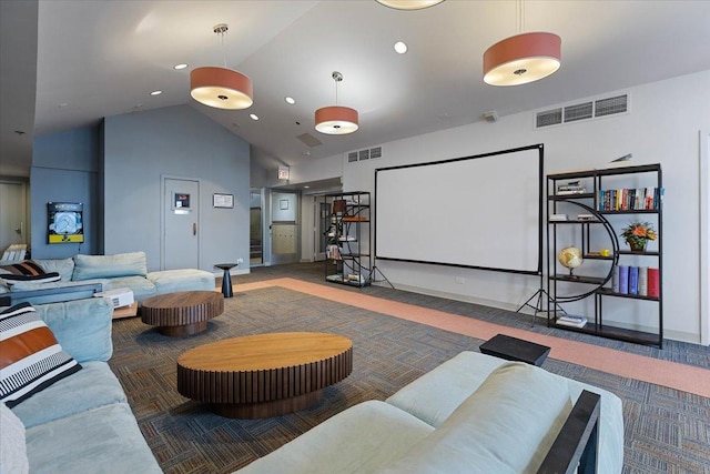 cinema room featuring dark colored carpet and high vaulted ceiling