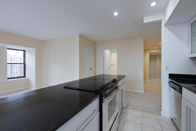 kitchen featuring white cabinetry, appliances with stainless steel finishes, and light tile patterned flooring