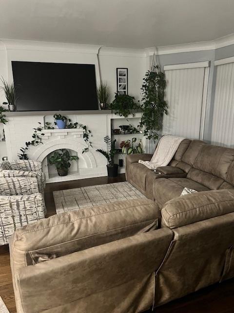 living room with ornamental molding and wood-type flooring