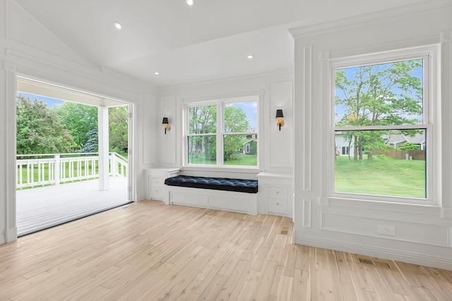 doorway to outside with vaulted ceiling and light hardwood / wood-style flooring