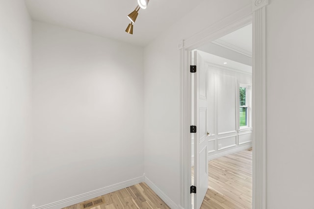 corridor with light hardwood / wood-style floors