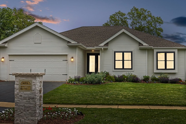 single story home with a yard and a garage