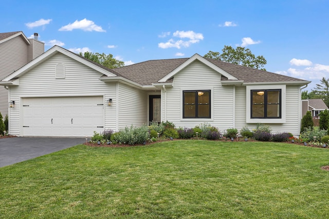 single story home featuring a garage and a front lawn