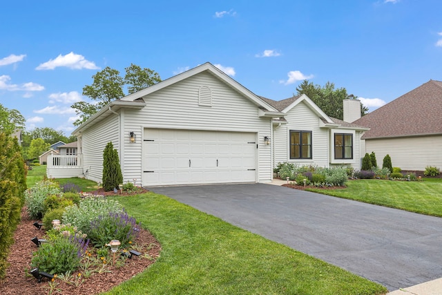 ranch-style house featuring a garage and a front lawn