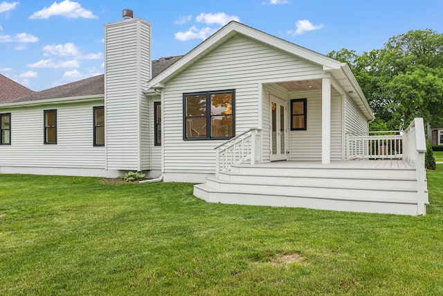 back of house with a lawn