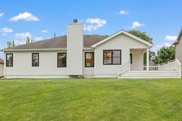 back of house featuring a lawn