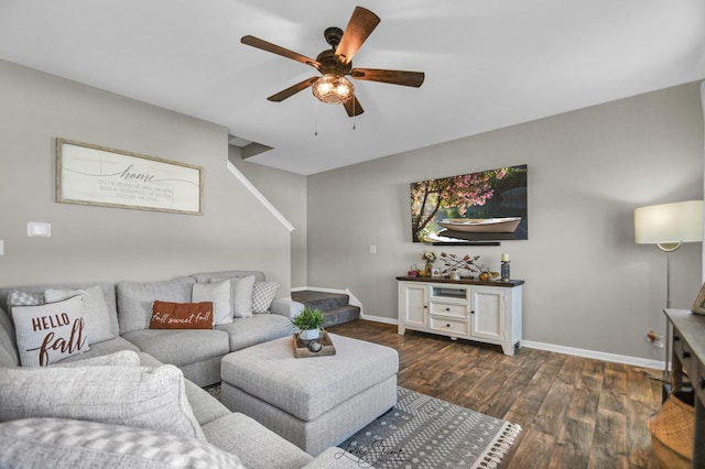 living room with dark wood-type flooring and ceiling fan