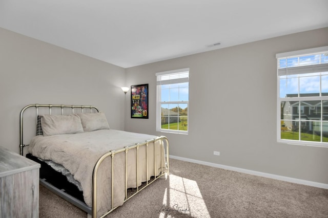 bedroom featuring light carpet