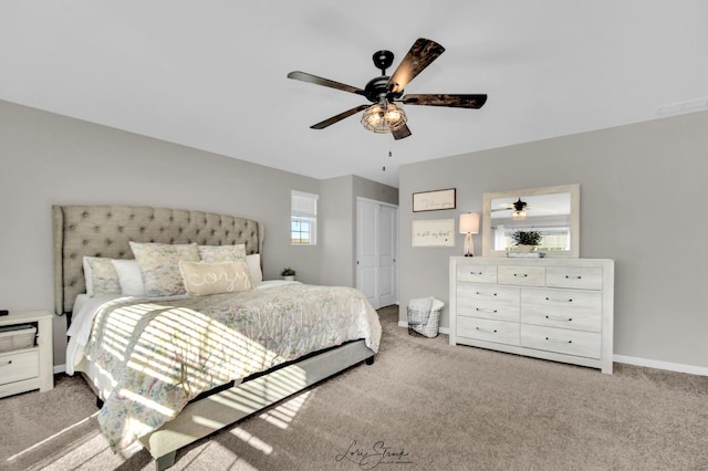 bedroom featuring ceiling fan, light colored carpet, and a closet