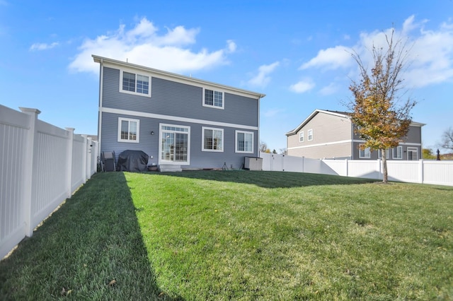 rear view of house with a yard