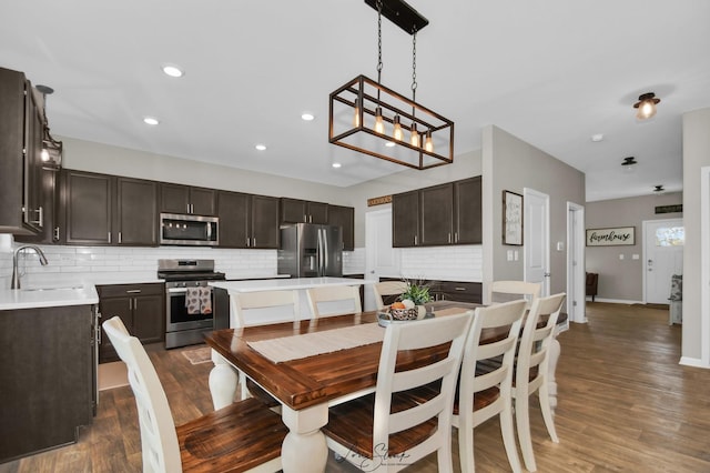 dining space with sink and dark hardwood / wood-style flooring