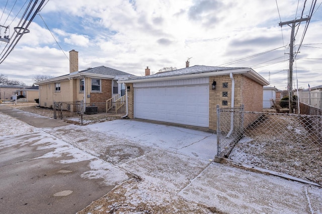 exterior space featuring cooling unit and a garage