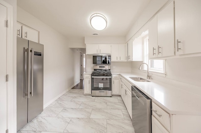 kitchen with white cabinetry, appliances with stainless steel finishes, and sink