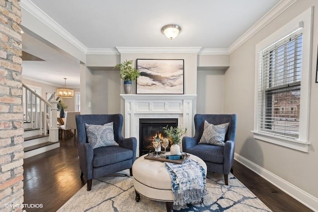 living area featuring dark hardwood / wood-style flooring, a notable chandelier, and ornamental molding