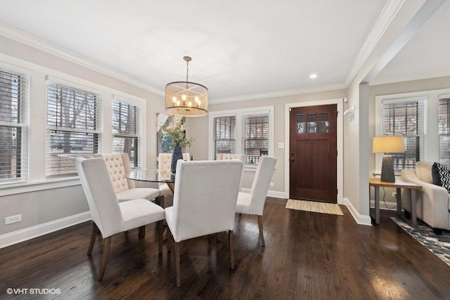 dining area with ornamental molding, dark hardwood / wood-style floors, and an inviting chandelier