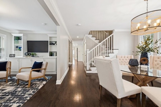 dining space with ornamental molding, dark hardwood / wood-style floors, and an inviting chandelier