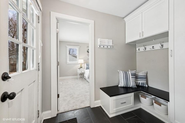 mudroom with dark tile patterned flooring