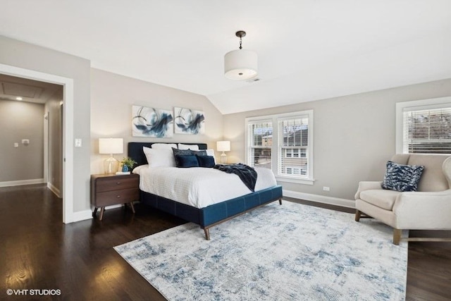 bedroom featuring dark hardwood / wood-style flooring and vaulted ceiling