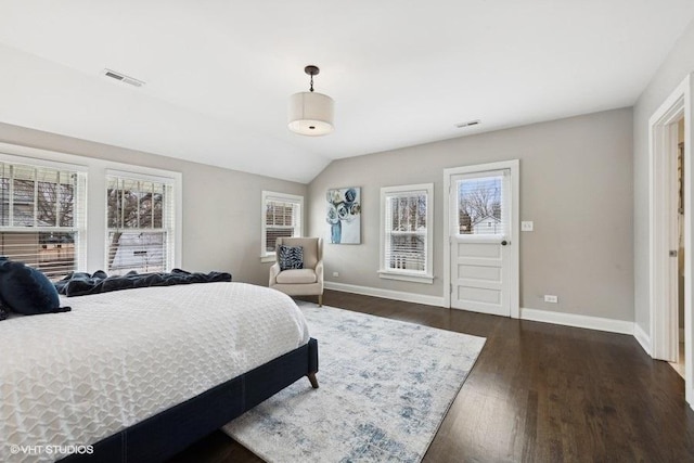 bedroom with dark hardwood / wood-style floors and vaulted ceiling