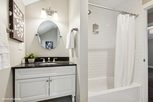 bathroom with vanity, lofted ceiling, and shower / tub combo