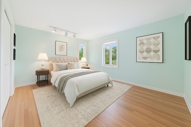 1247 Highpoint Ln, Northbrook, IL 60062 - bedroom featuring rail lighting, baseboards, and light wood-type flooring