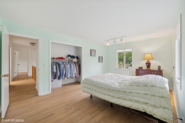 1247 Highpoint Ln, Northbrook, IL 60062 - bedroom with light wood-style flooring, track lighting, baseboards, and a closet