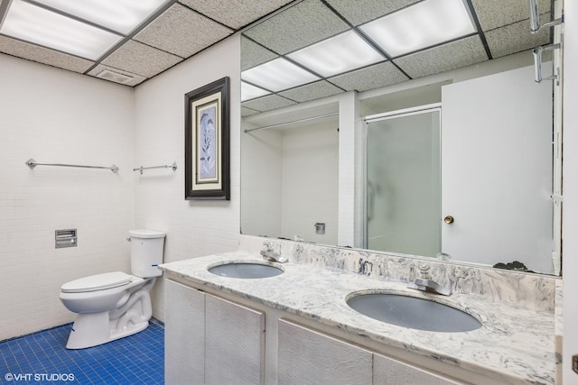 1247 Highpoint Ln, Northbrook, IL 60062 - full bathroom with toilet, tile patterned floors, a shower stall, double vanity, and a drop ceiling