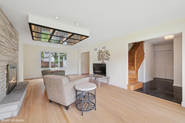 1247 Highpoint Ln, Northbrook, IL 60062 - living area featuring a fireplace, stairs, wood finished floors, baseboards, and recessed lighting