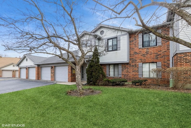 view of front of house featuring a garage and a front lawn