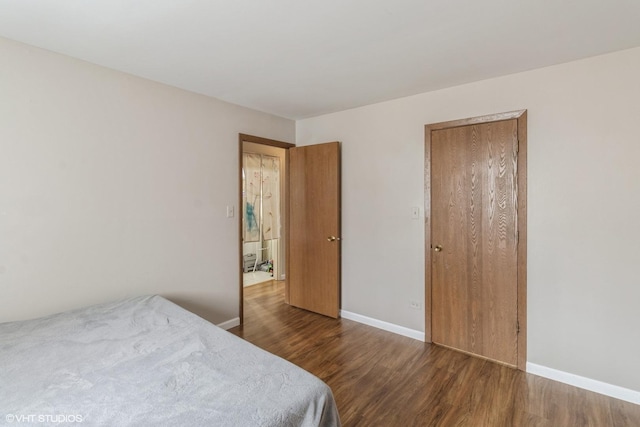 bedroom with dark hardwood / wood-style flooring