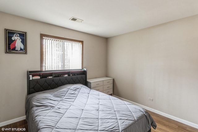 bedroom with hardwood / wood-style flooring