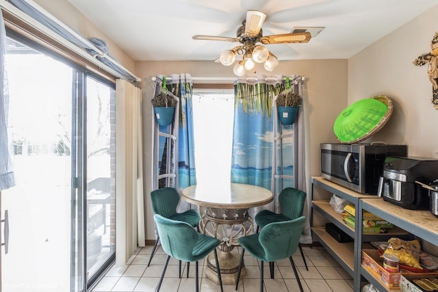 dining space featuring light tile patterned floors and ceiling fan