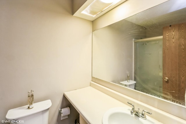 bathroom with toilet, vanity, and walk in shower