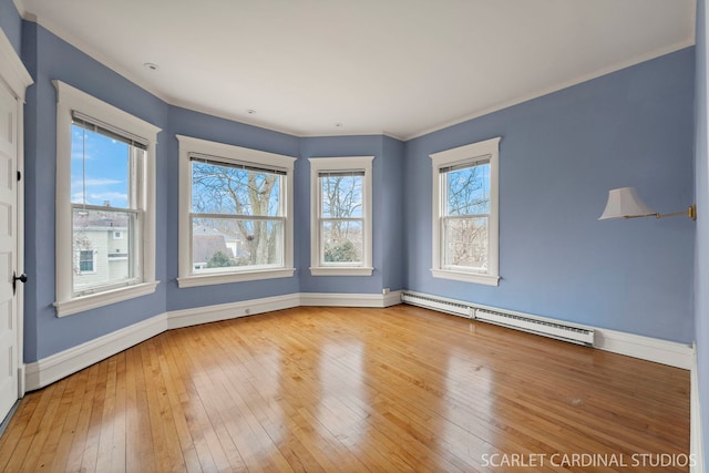 unfurnished room featuring hardwood / wood-style flooring, a baseboard radiator, and crown molding