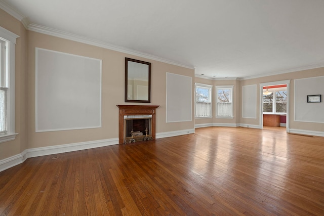 unfurnished living room with ornamental molding and light hardwood / wood-style floors