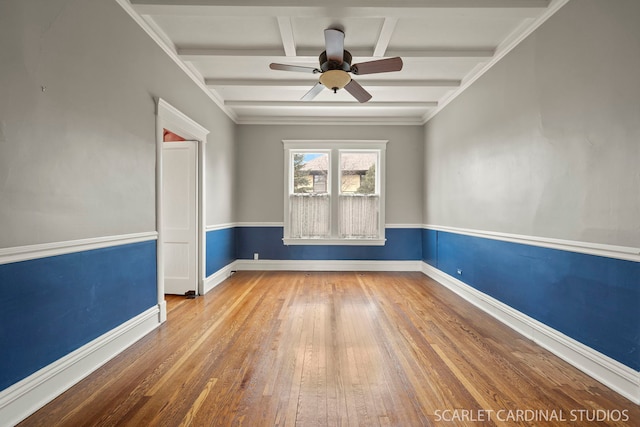 unfurnished room with beam ceiling, wood-type flooring, and ceiling fan