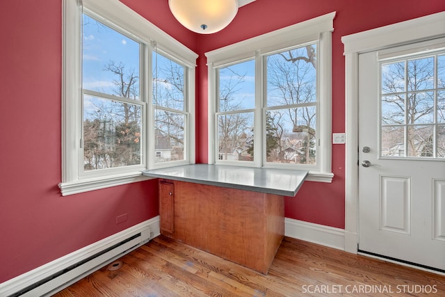 interior space with a baseboard radiator and light hardwood / wood-style floors