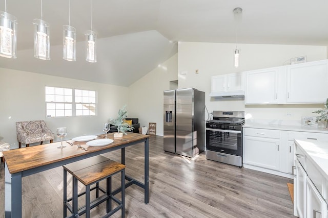 kitchen with pendant lighting, stainless steel appliances, light hardwood / wood-style flooring, and white cabinets