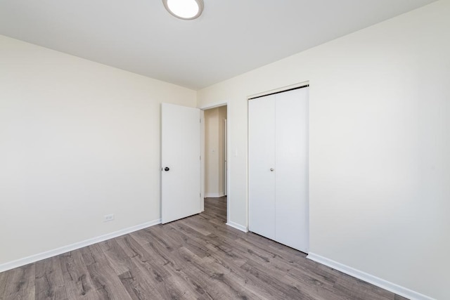 unfurnished bedroom with a closet and light hardwood / wood-style flooring