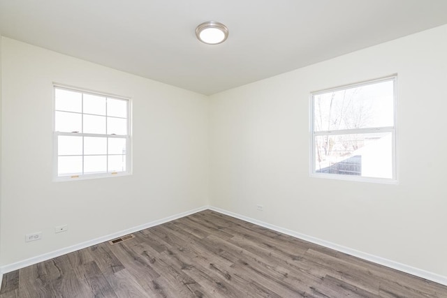 spare room with wood-type flooring