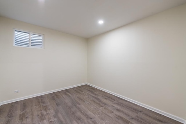 unfurnished room with dark hardwood / wood-style flooring