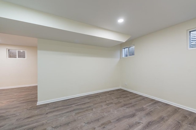 basement with hardwood / wood-style floors and a healthy amount of sunlight