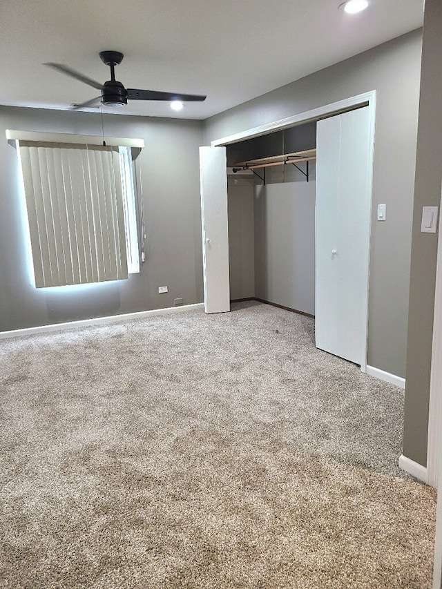 unfurnished bedroom with carpet floors, ceiling fan, and a closet