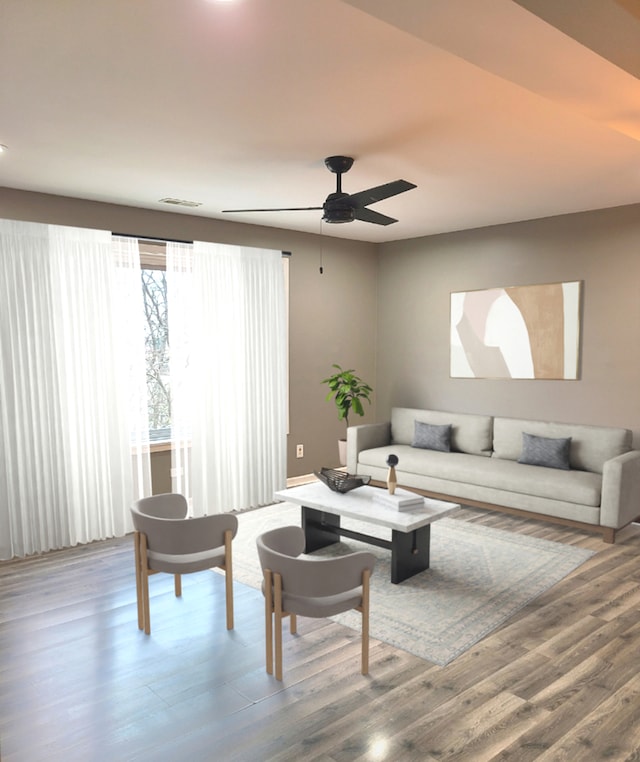 living room with wood-type flooring and ceiling fan