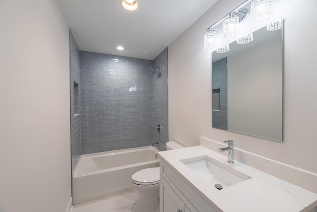 full bathroom with tiled shower / bath, vanity, and toilet